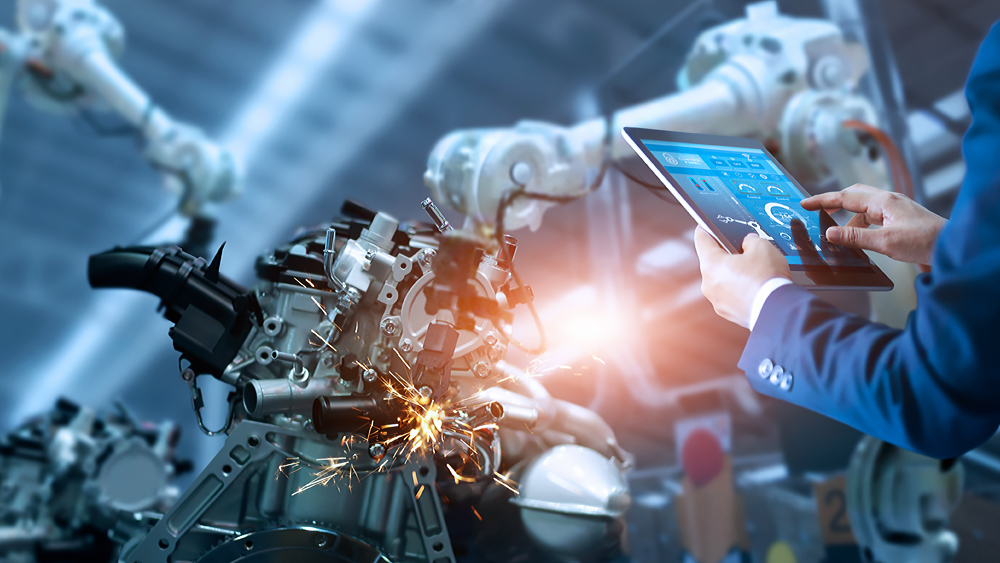 Engineer manager check and control automation robot arms machine in intelligent industrial factory on real time monitoring system software. Welding robotics and digital manufacturing operation.
