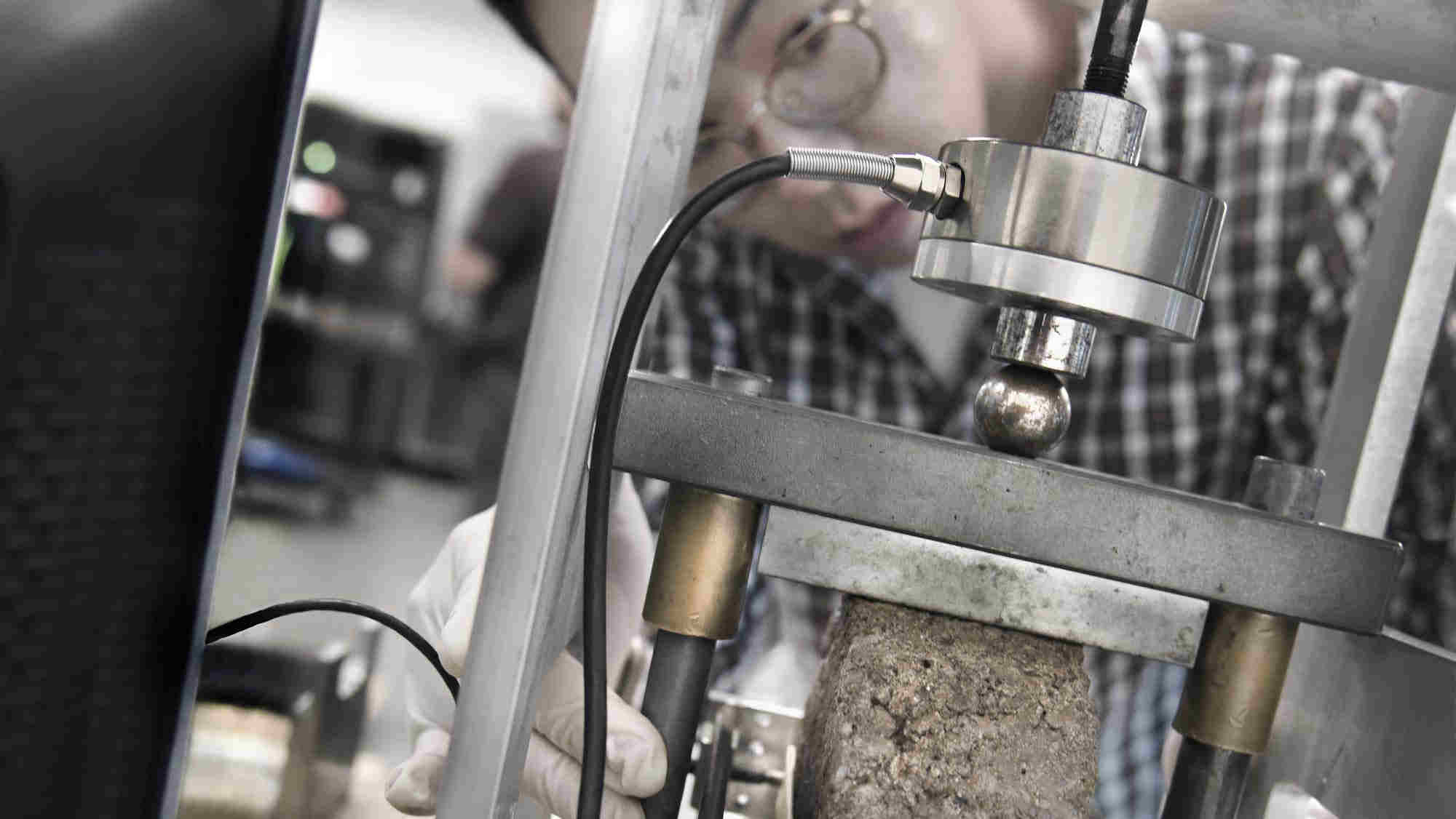 researcher examining asphalt core sample