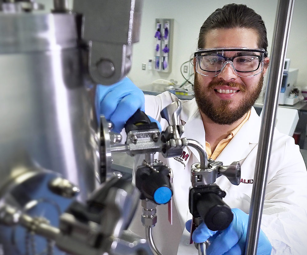 research center researcher adjusting equipment