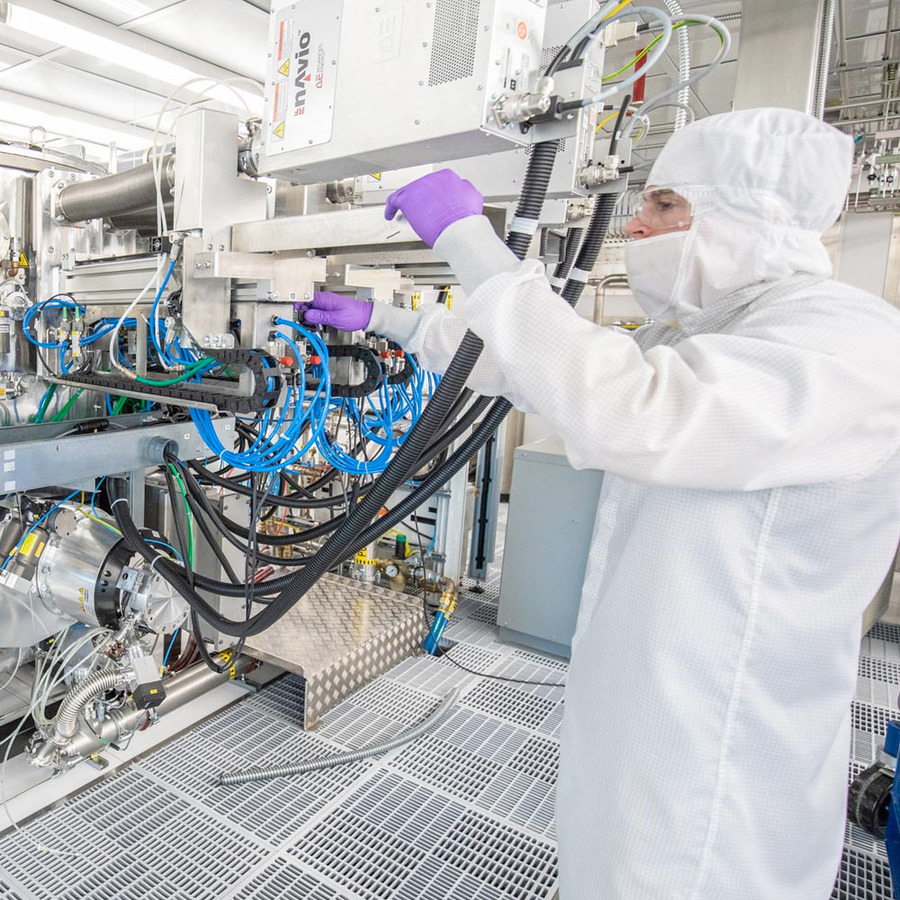 TEES researcher adjusting equipment in research facility