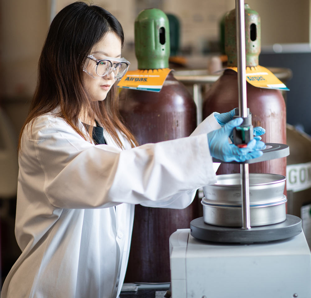 researcher handling lab equipment