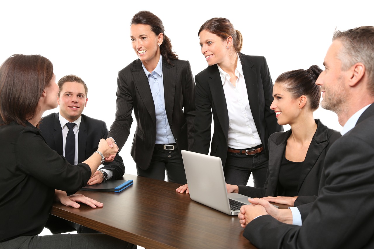 A group of people in suits discussing a project.