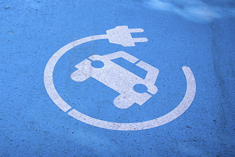 Blue background with white spray painting of a car and electrical cable around it