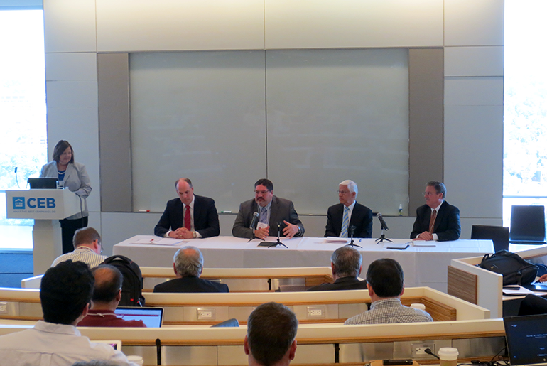 Panel moderator Flora Flygt, at a podium with A. Wade Smith, Tony Montoya, Bob Mitchell, and H. B. “Trip” Doggett sitting in the panel.