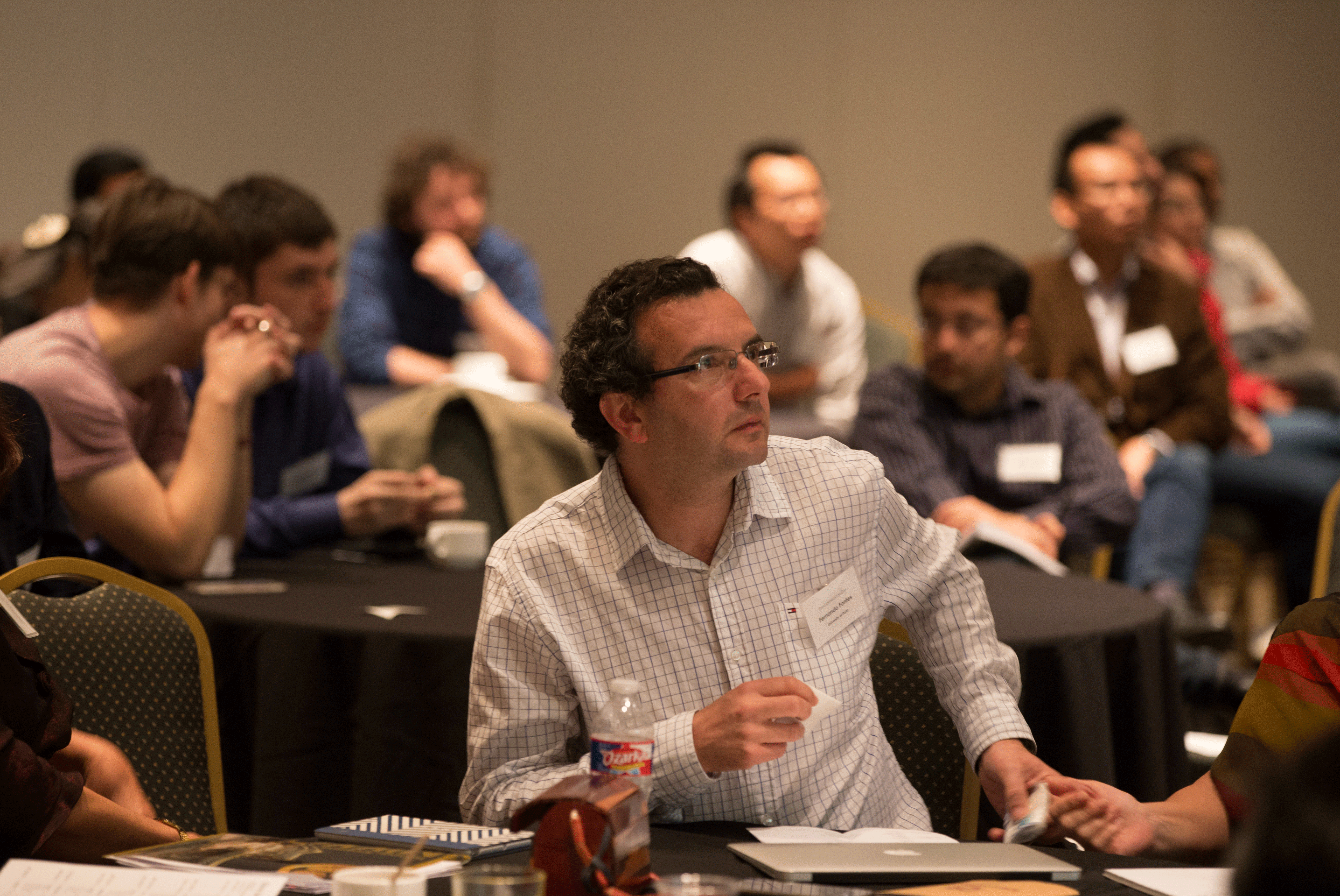 Texas A&M Energy Institute Conference Attendee Surrounded by Other Attendees in a Ballroom