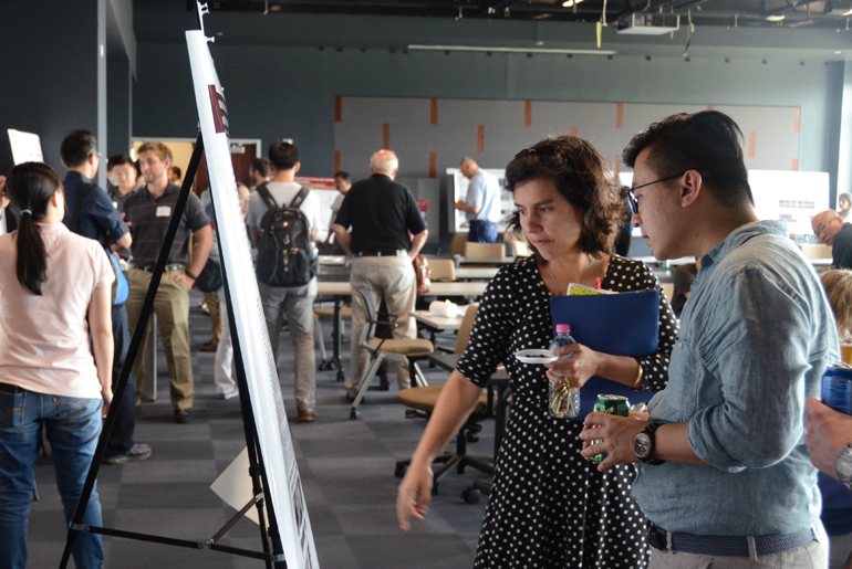 Two Individuals Looking At A Board In The ENG-LIFE Workshop