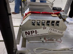 Mechanical hardware with stickers of Nuclear Power Institute and Texas A&amp;M.