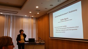 Image of presenter presenting a slide with words of Atomic Bomb Survivor's Testimony