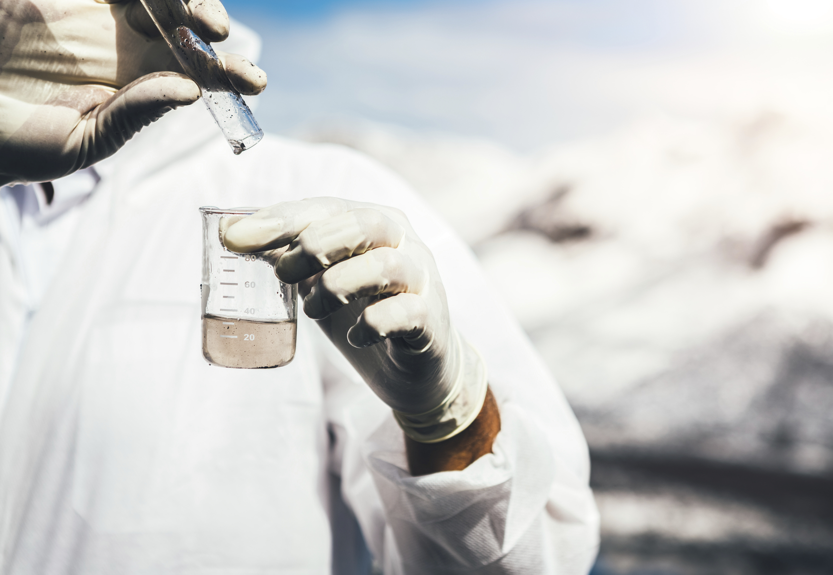 Scientist Holding a Test Tube and Flask