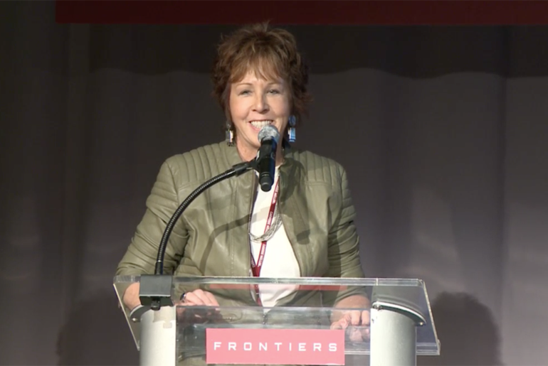 Dr. Robin Murphy speaking from a podium at White House Frontiers Conference.
