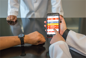 Smart phone with prototype of PTSD research screen and smart watch.