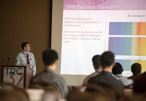 Image of an individual giving a presentation in front of an audience