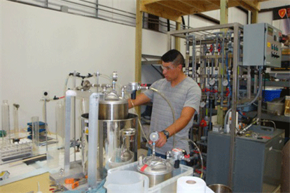 Image of an individual working with metallic tools