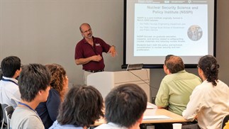 Image of an individual giving a presentation in front of an audience