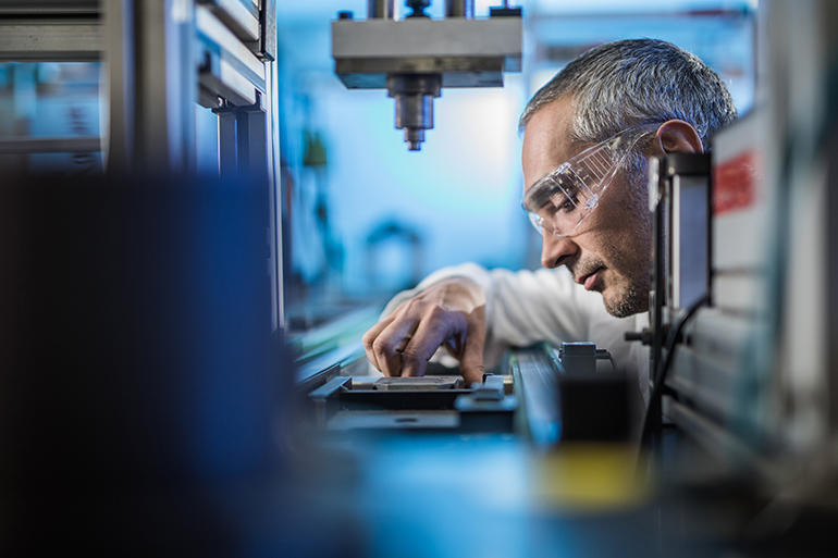 Man wearing eye protection in the lab.