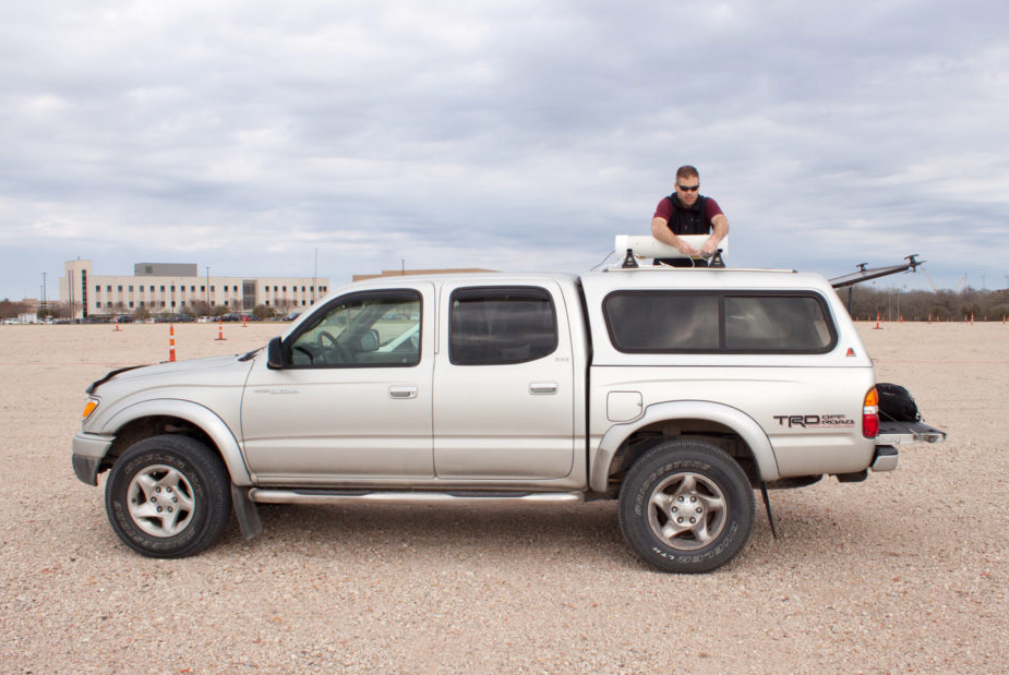 James Falkner working on an equipment on a vehicle.