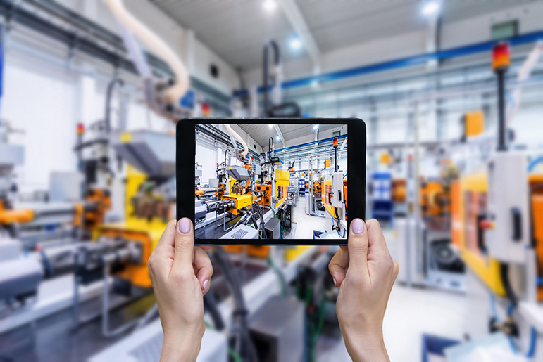 Two hands holding a tablet that showcases a laboratory
