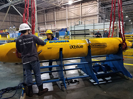 Students inspect Marlin, orange submarine.
