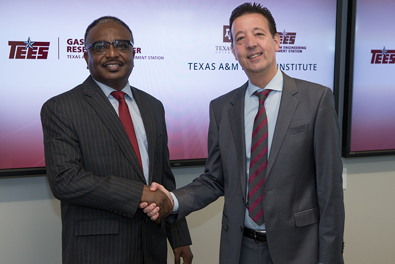 Dr. Nimir O. Elbashir and Dr. Stratos Pistikopoulos shaking hands.