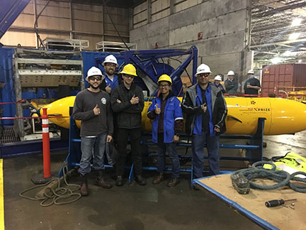 Xprize team poses in front of Marlin.