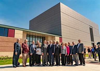 Group photo of elected officials standing outside of the center.