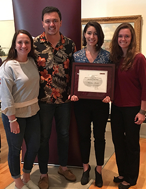 Group photo with Madeleine S. Durkee holding Phil Gramm Fellowship Award.