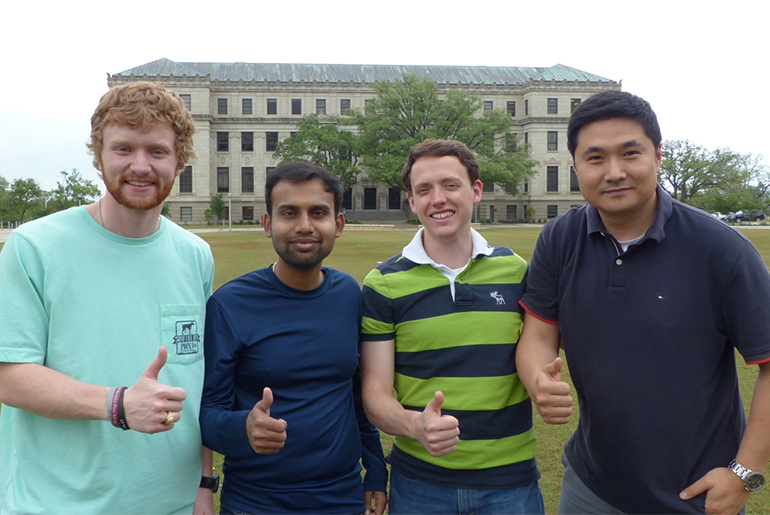 The four students with thumbs up 