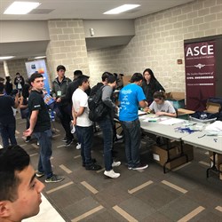 Students lining up filling out paperwork