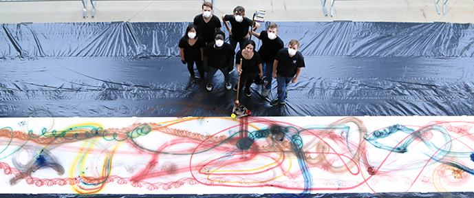 Rosemarie Fiore's group standing next to their artwork