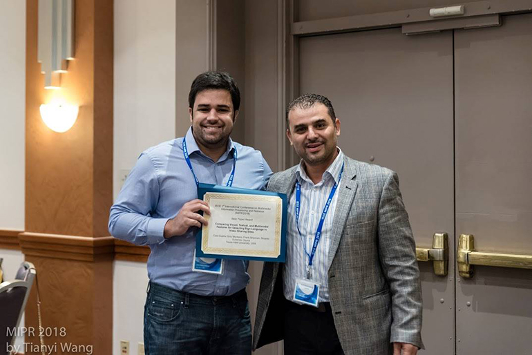 Researchers holding the certificate