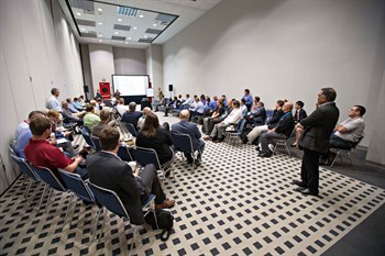 People gathered in a room for a TPS Technical session 
