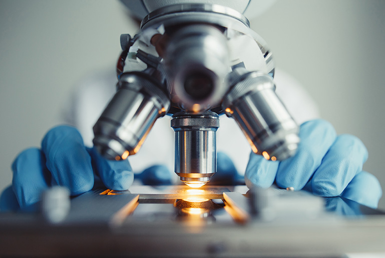 Researcher by microscope