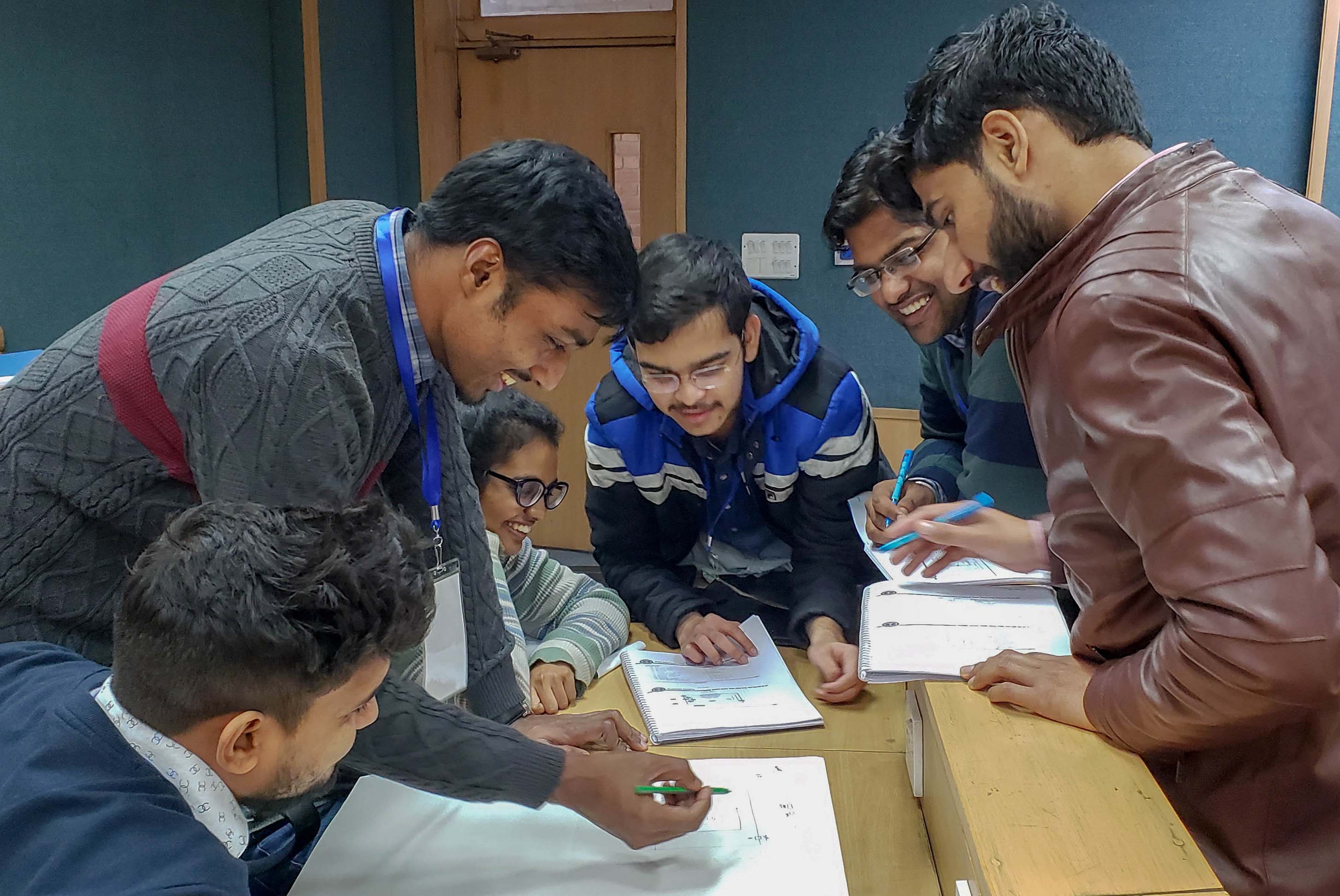 Students gathered around desk during workshop