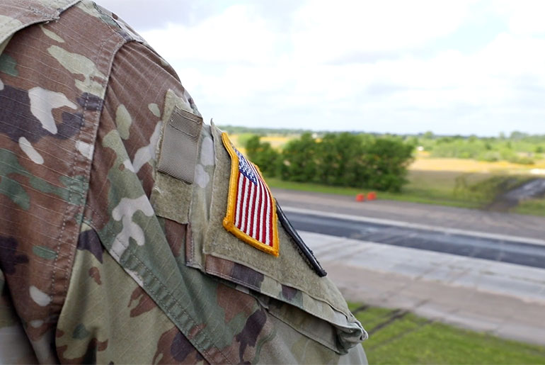 Soldier in uniform looking out onto RELLIS Campus