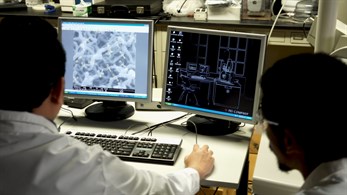 Two researcher looking at computer screens.