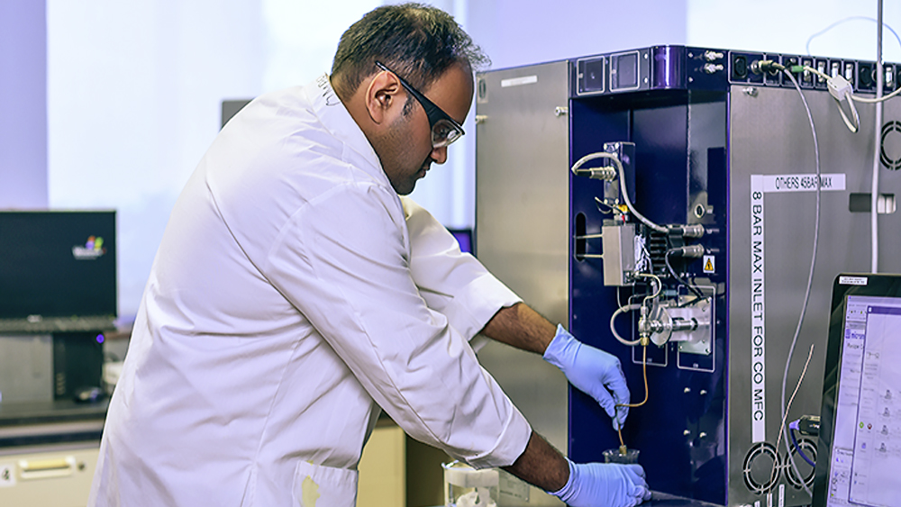 Researcher looking into device