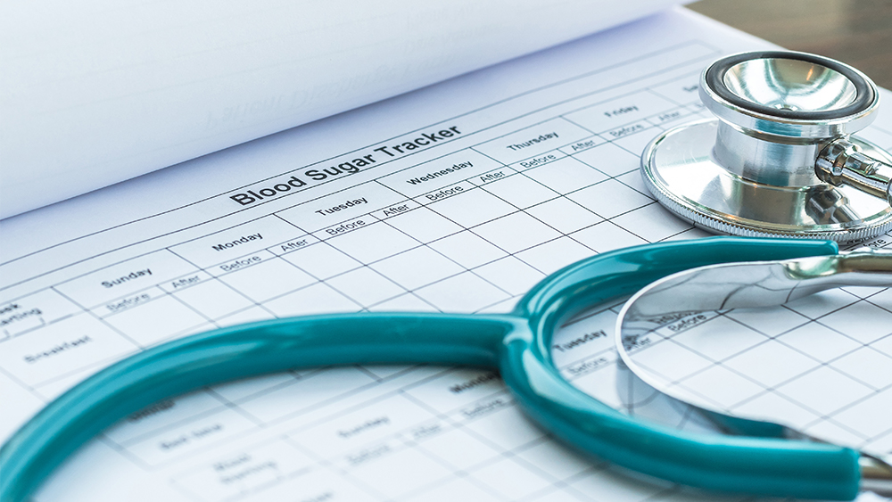 Stethoscope on a chart for monitoring blood sugar.