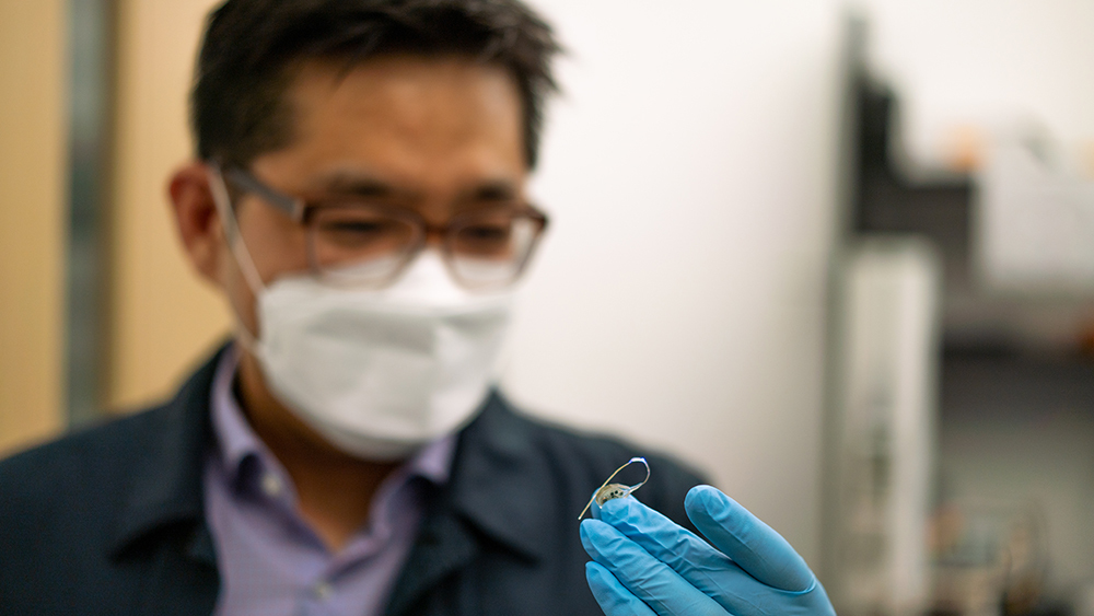 Sung II Park holding wireless optogenetic device