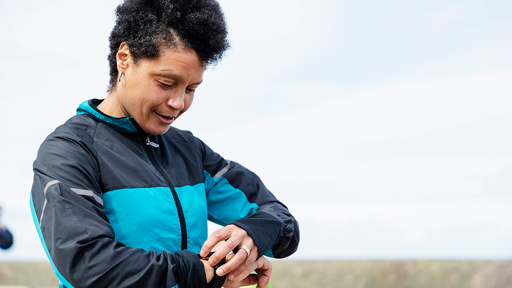 A woman looking into her smartwatch.