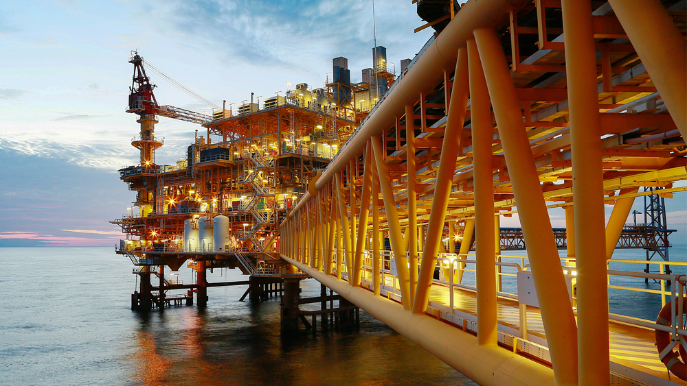 Oil rig on ocean in the evening.