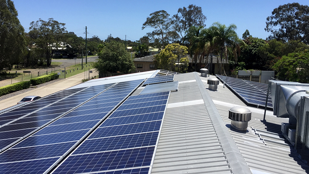 A solar panel on the rooftop of a commercial building.