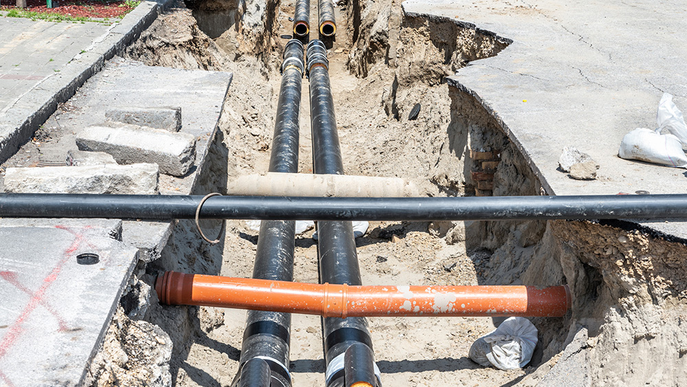 Underground utility line reparation and reconstruction site parallel to a street.