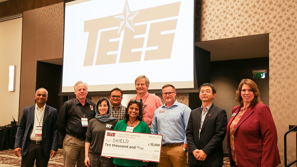 SHIELD research project team members being presented a large $10,000 check from Dr. Cindy Lawley, far right. 